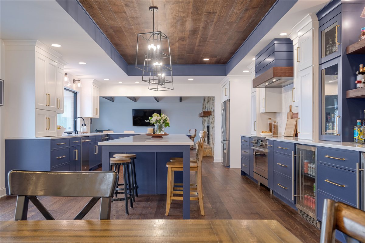Blue kitchen with an island, wood ceiling and pendant lights, Moss Lake kitchen