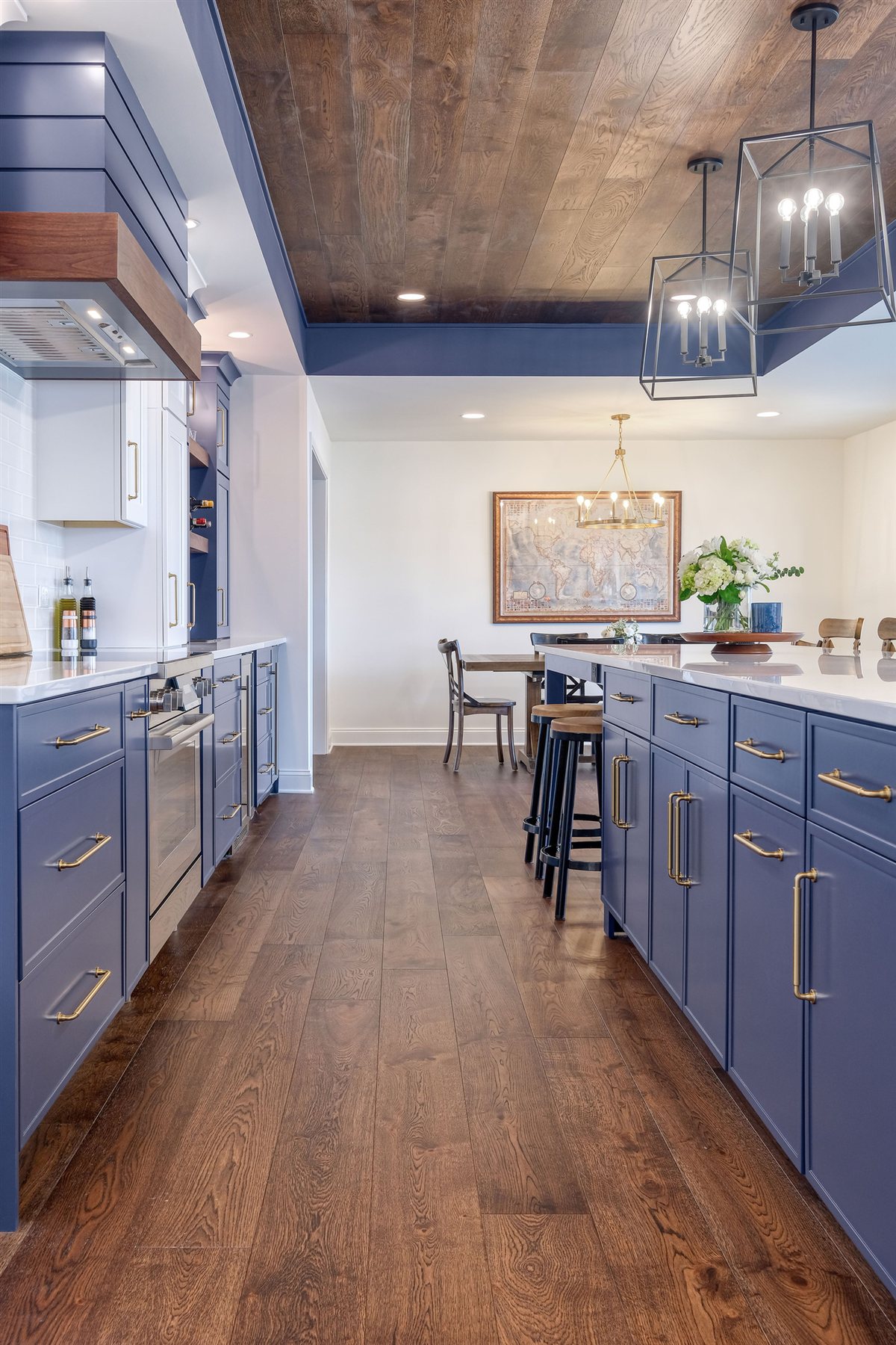 Blue cabinet run with a wood floor, Moss Lake kitchen