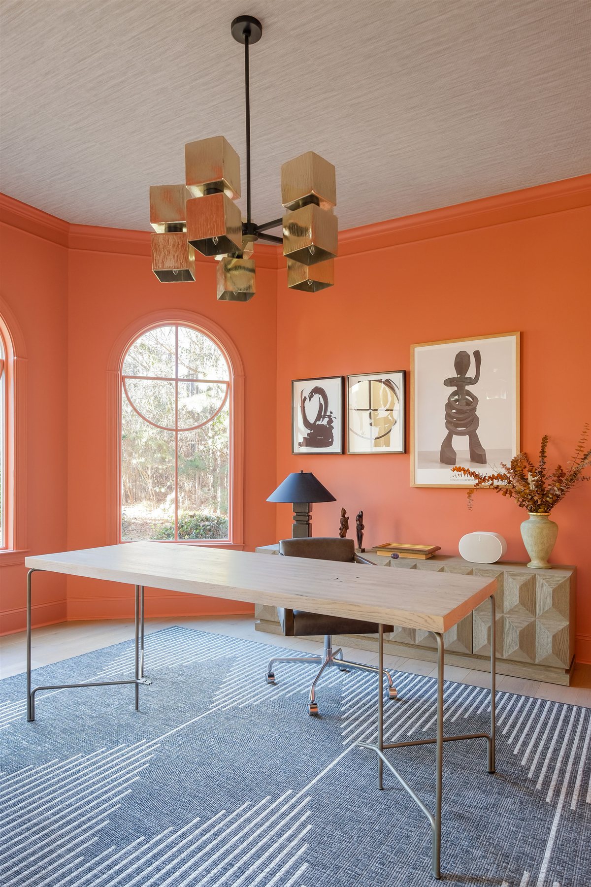 Orange-walled dining room with a brass chandelier, Lake Wylie renovation