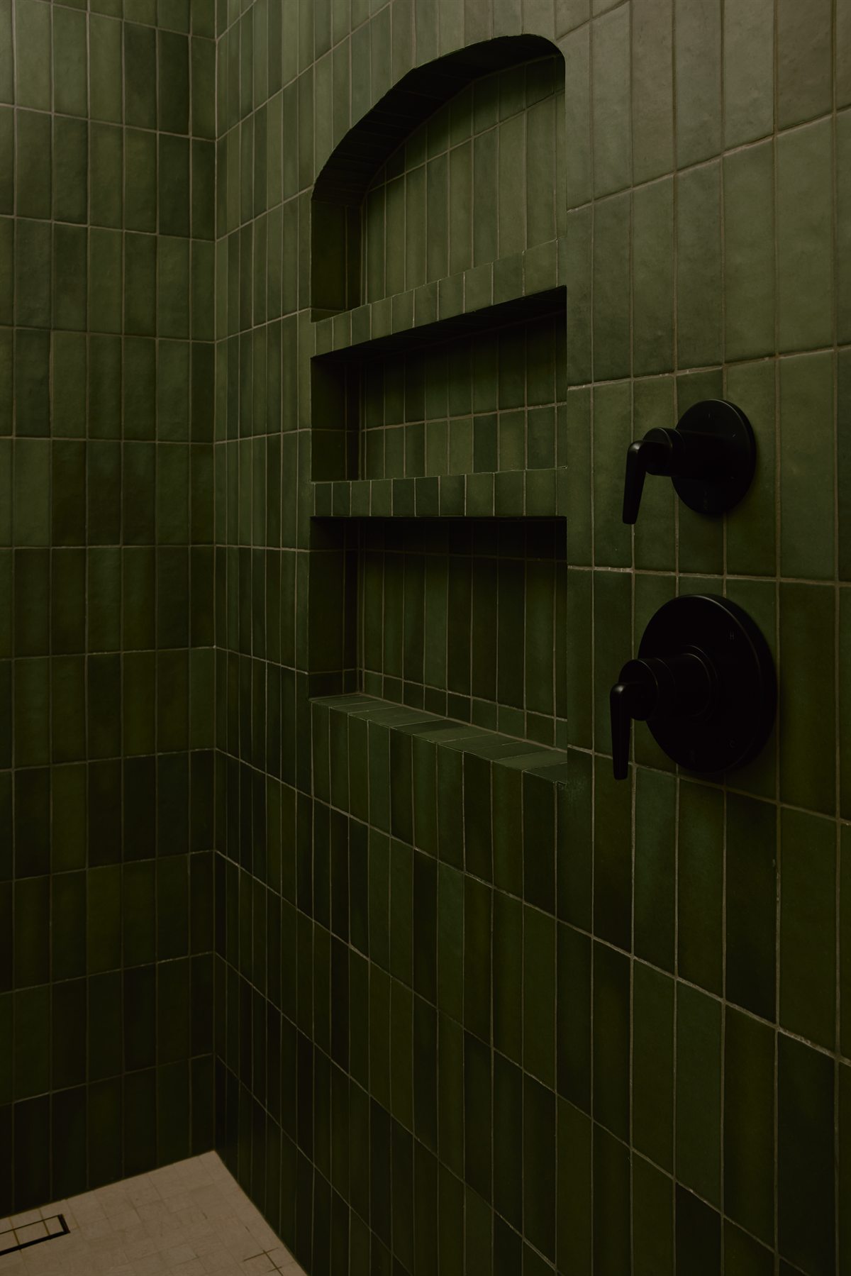 Curbless shower in deep green handmade tile with arched niches and matte black fixtures, Lansdowne, Charlotte