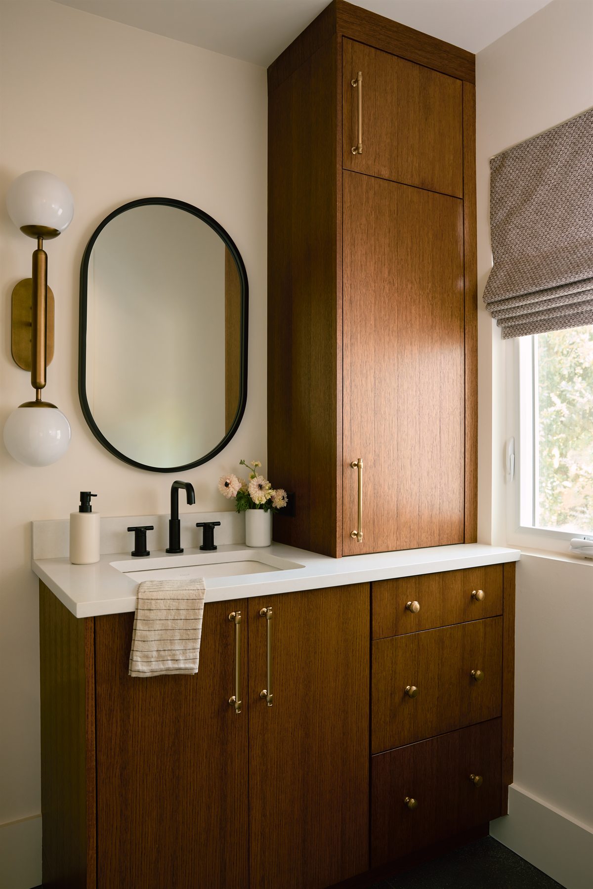 Second bath vanity with a tall wood cabinet, oval mirror and globe sconce, Lansdowne renovation, Charlotte