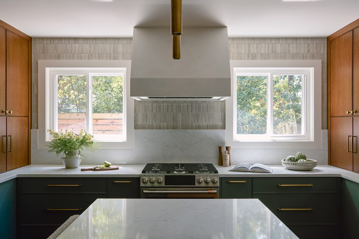Plaster range hood centered between two windows over green cabinetry, Lansdowne kitchen remodel, Charlotte