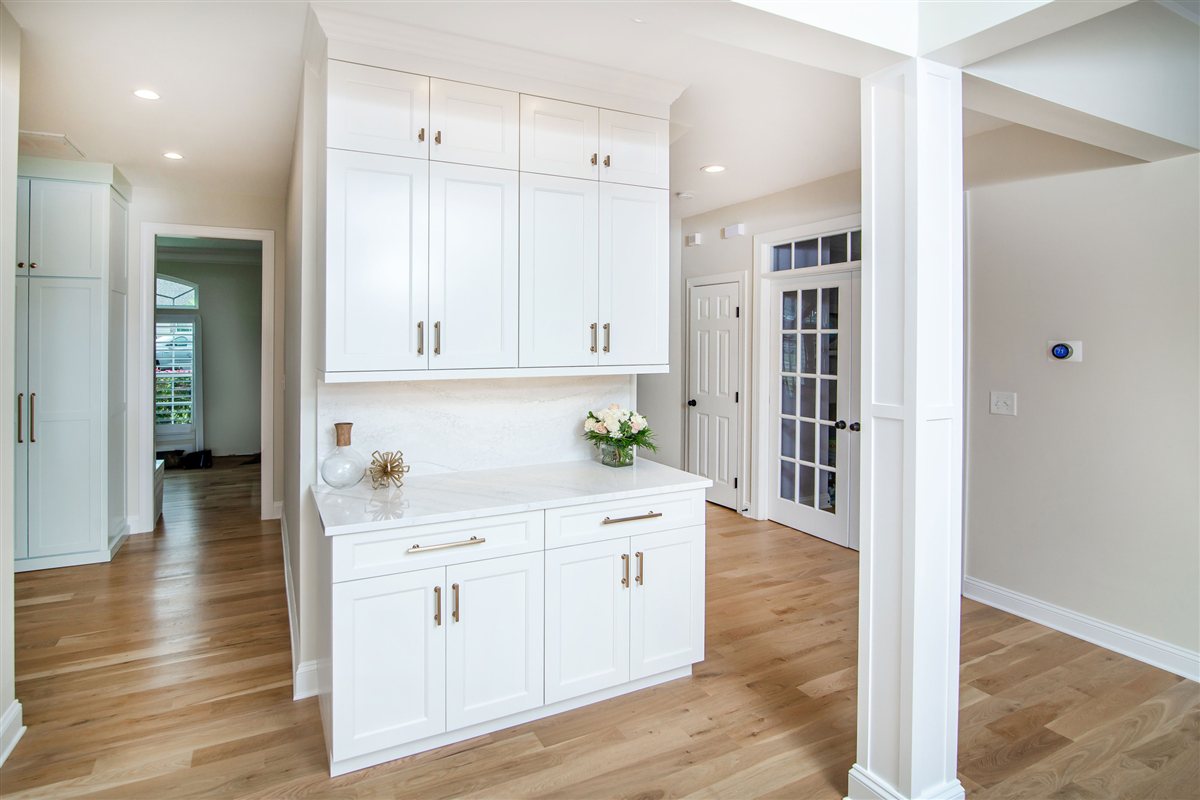 White built-in cabinets along the hallway, Monroe renovation