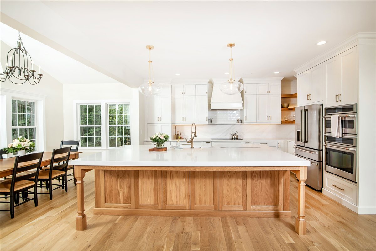 Wood island with a white top and white perimeter cabinetry, Monroe kitchen