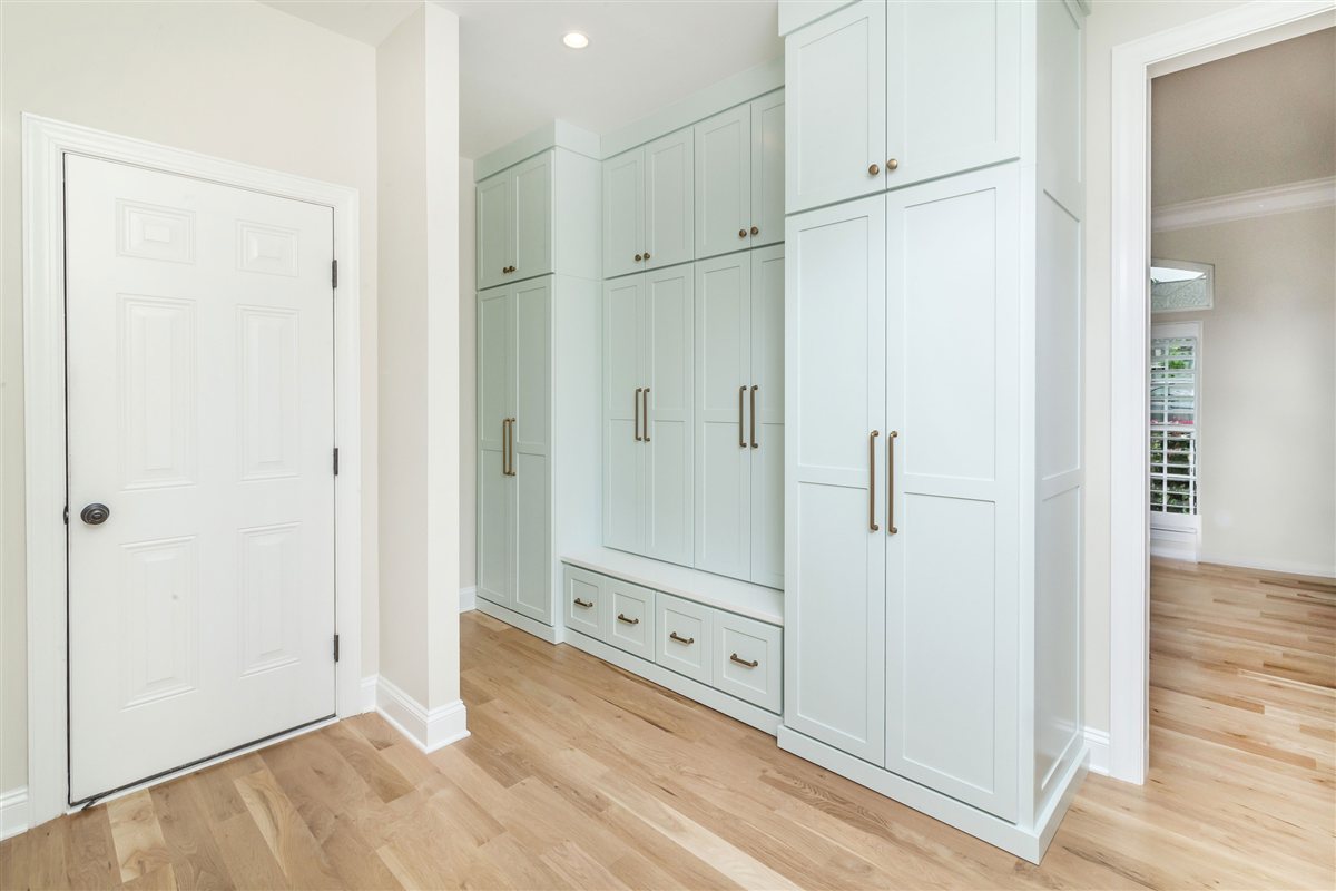 Mudroom built-ins beside a paneled door, Monroe renovation