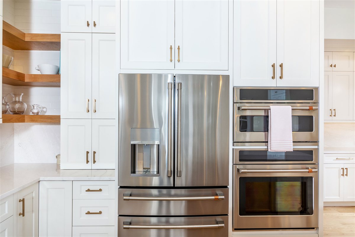 Stainless refrigerator and double wall ovens in white cabinetry, Monroe kitchen