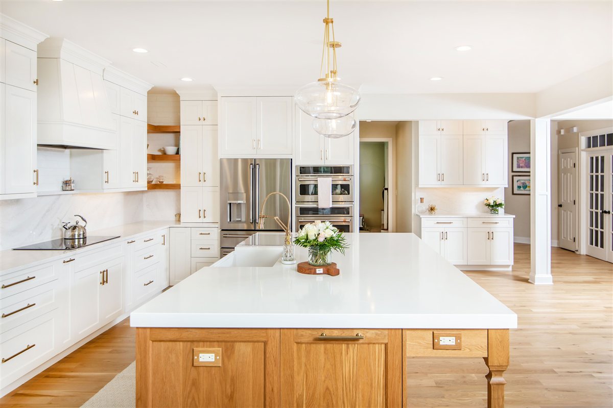 White island with a wood base under pendant lights, Monroe kitchen