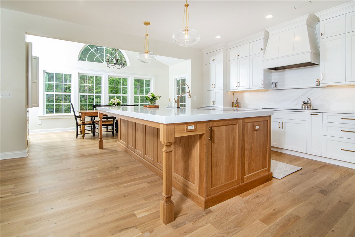 Kitchen island and dining area beneath an arched window, Monroe kitchen