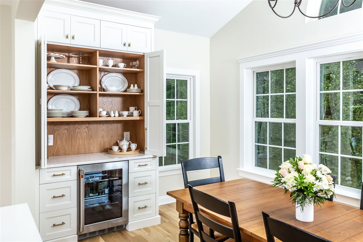 Built-in hutch with open shelves and a beverage fridge beside the dining area, Monroe kitchen
