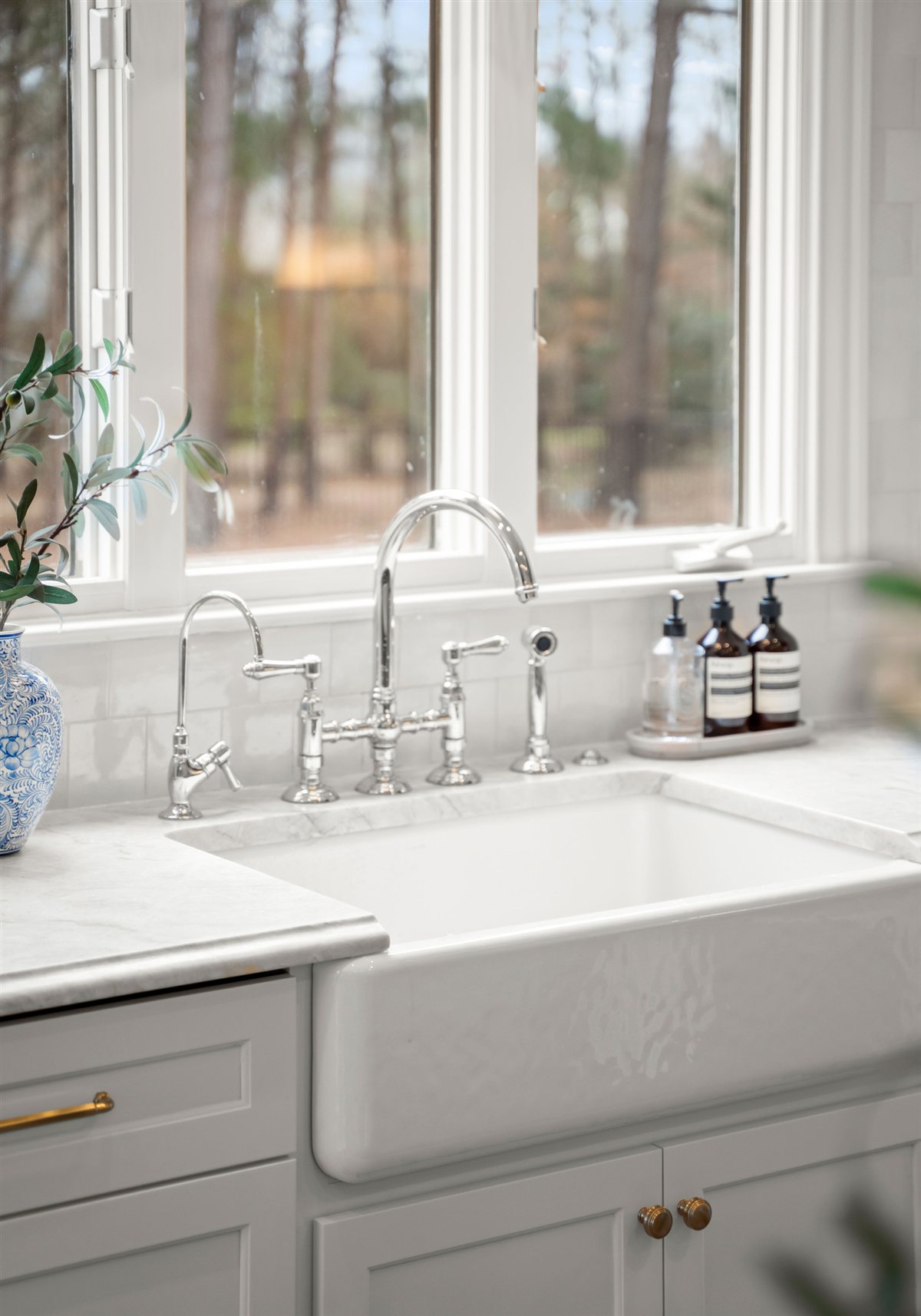 White farmhouse sink under a window, The Point kitchen
