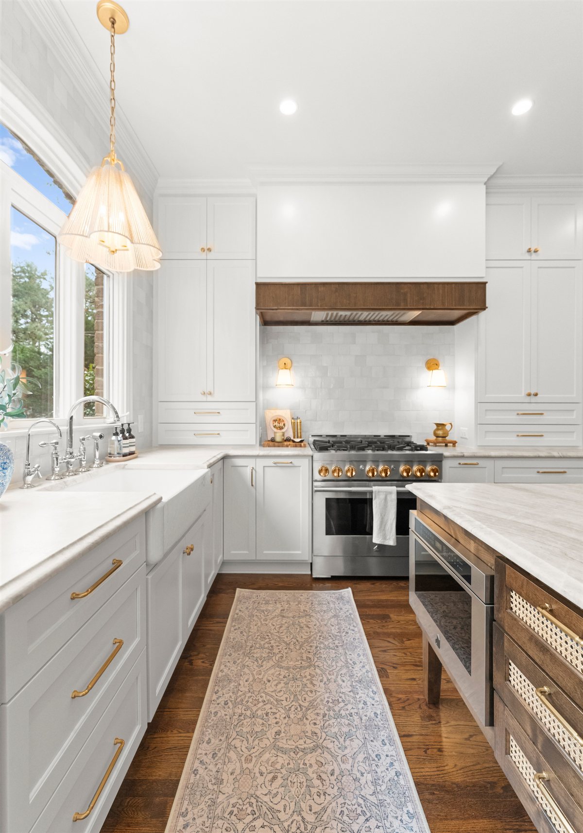 Galley view of the kitchen toward a range and wood hood, The Point renovation