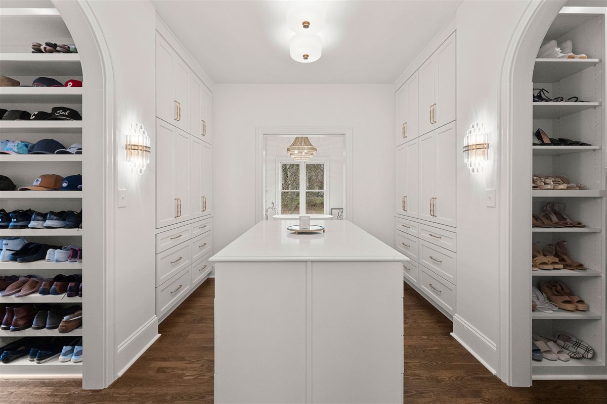 Closet with shoe shelving and a center island, The Point renovation