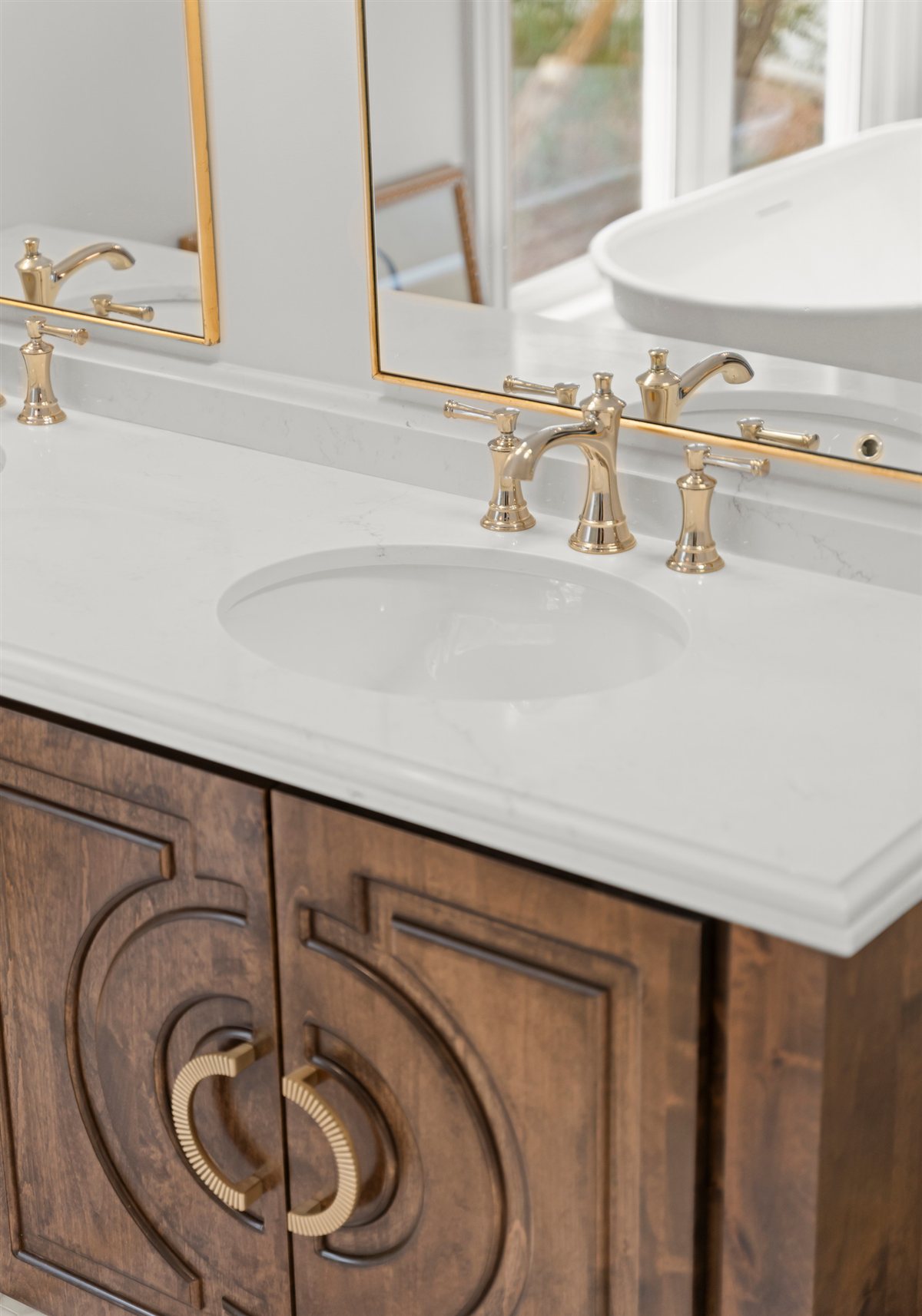 Carved wood vanity with a brass faucet, The Point renovation