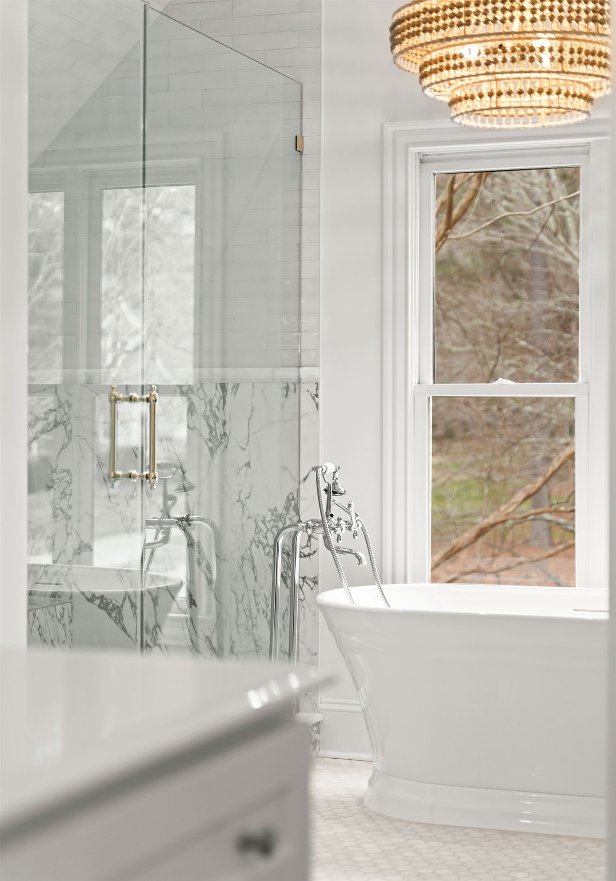 Glass shower beside a window in the primary bath, The Point renovation