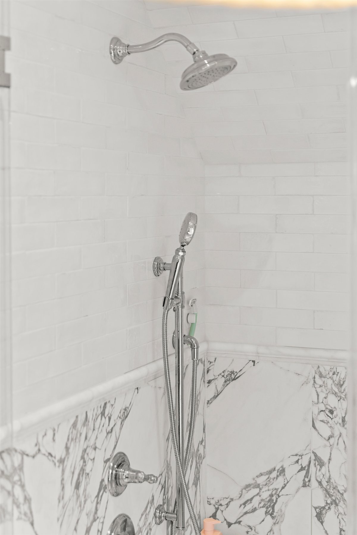 Marble shower with white tile above, The Point renovation