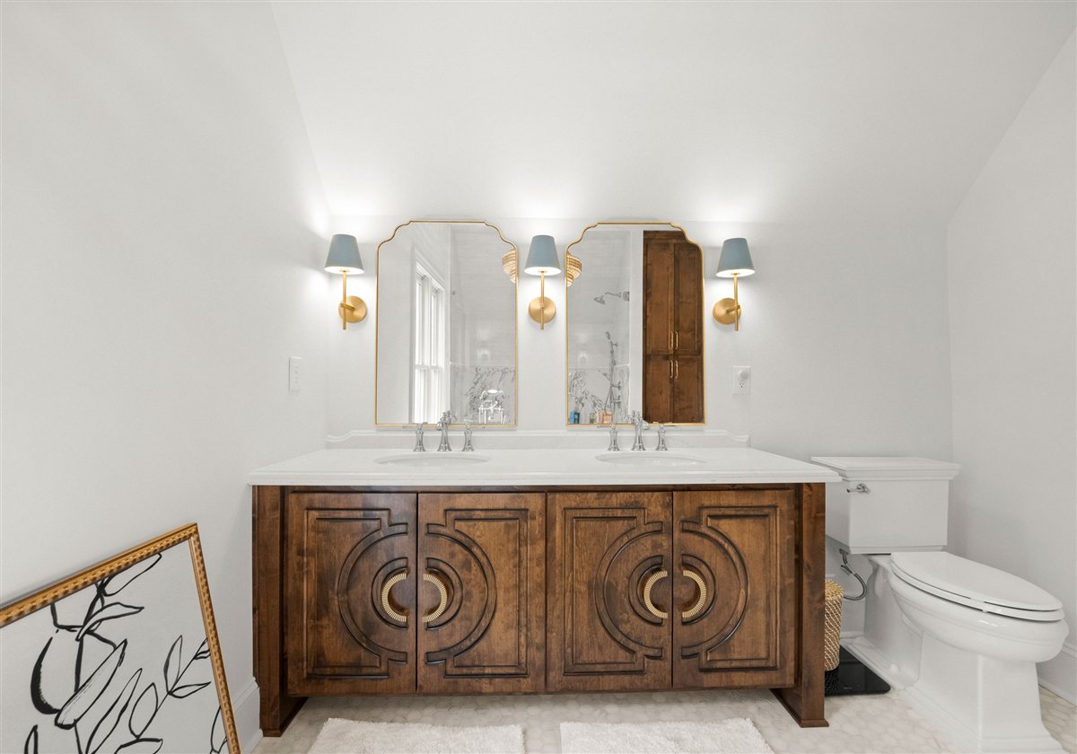 Carved wood vanity with blue-shaded sconces, The Point renovation