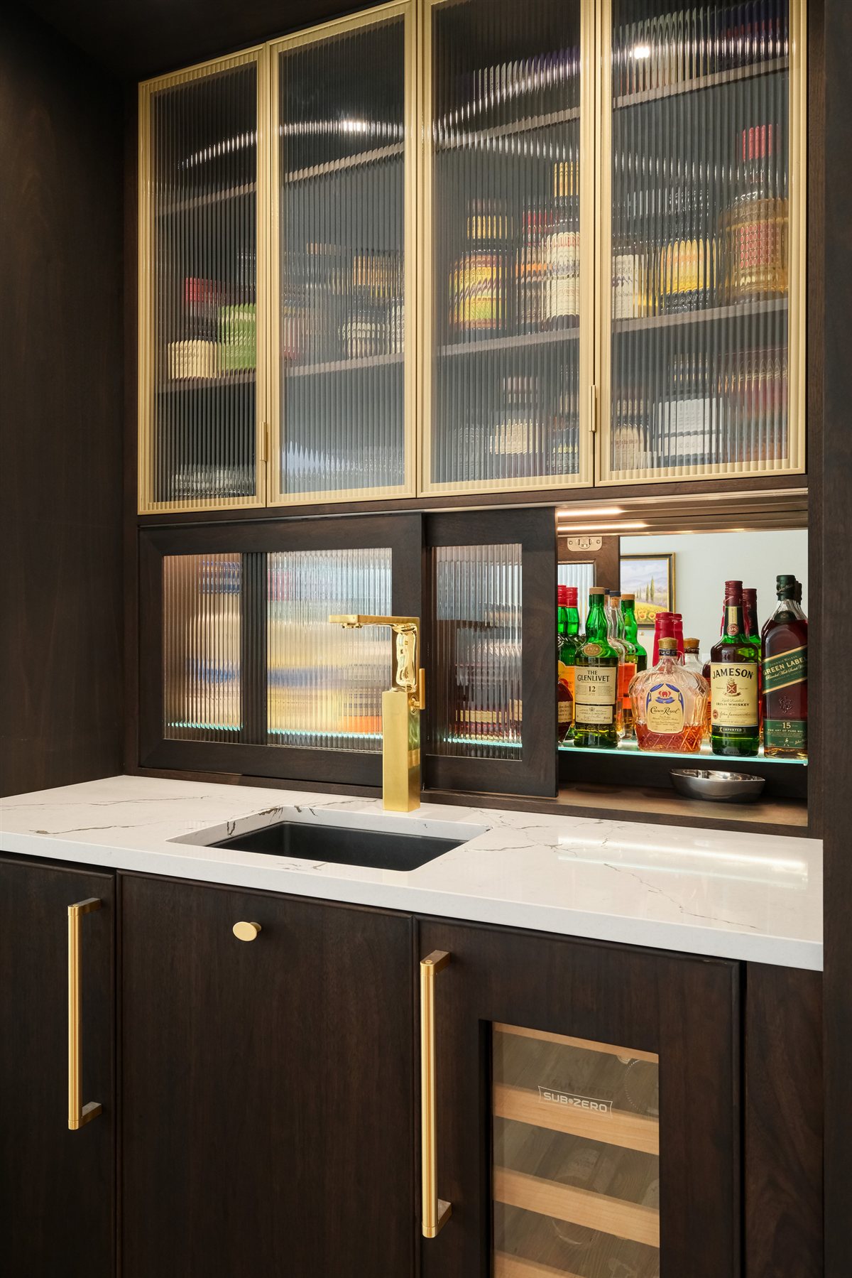 Bar cabinet with glassware and a beverage fridge, Pellyn Wood renovation