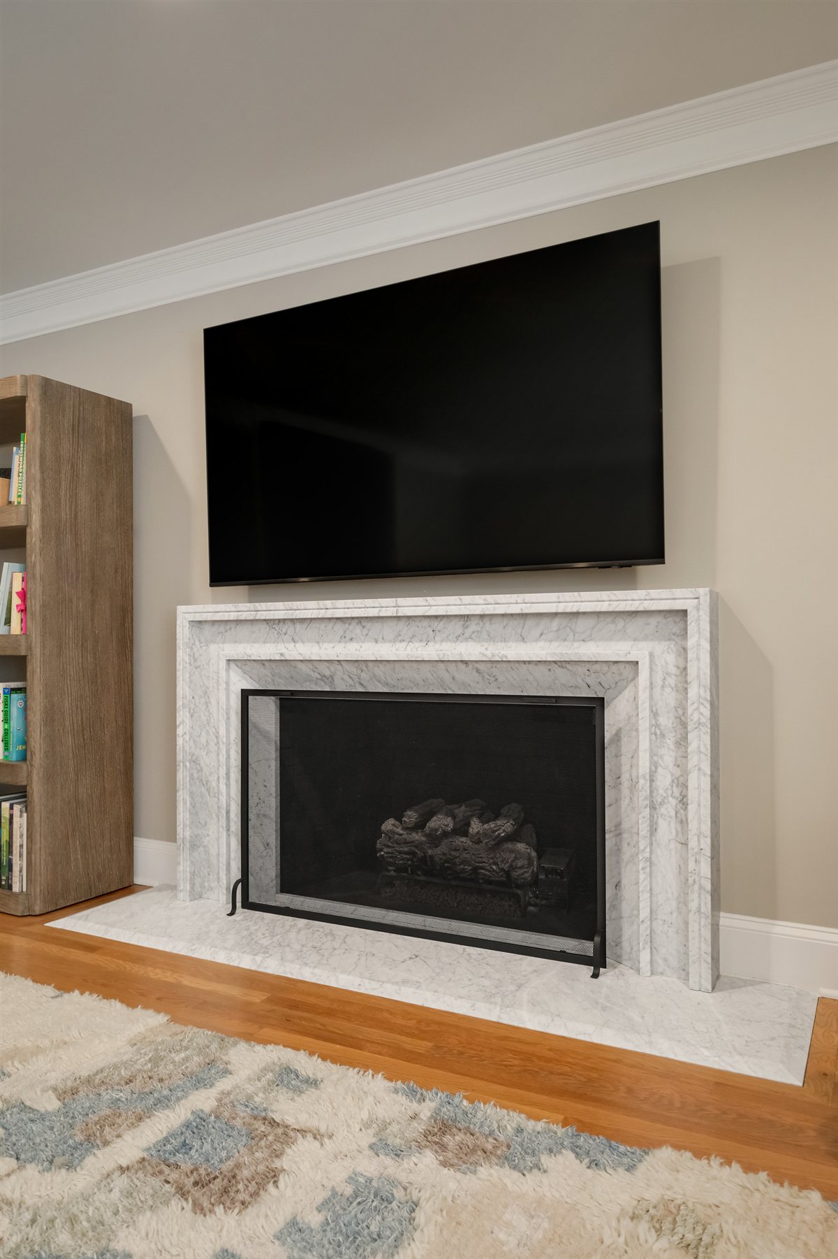Living room fireplace with a mounted television, Pellyn Wood renovation