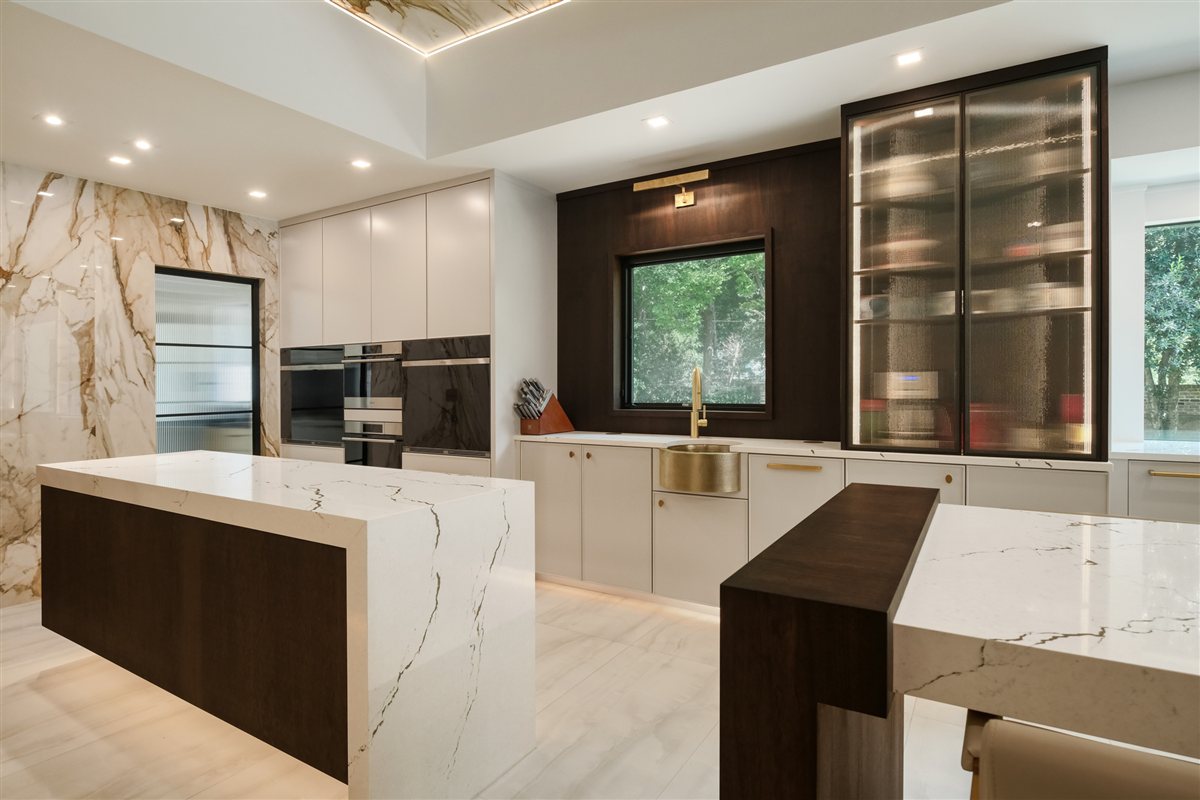 Kitchen with a walnut island end and glass-front cabinetry, Pellyn Wood renovation