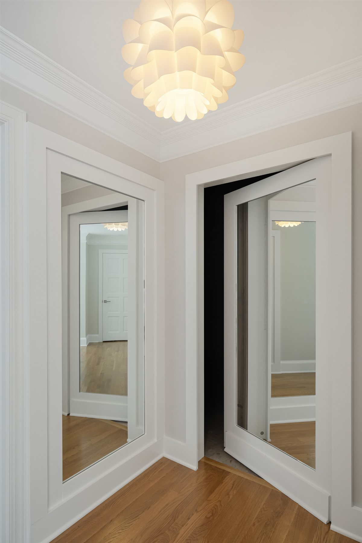Mirrored closet doors in a white hallway, Pellyn Wood renovation
