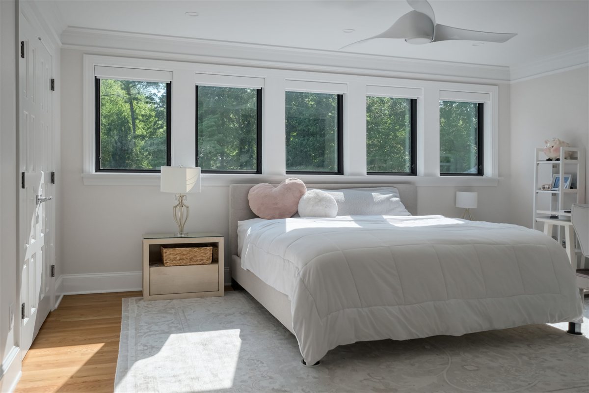 Bedroom with a row of black-framed windows, Pellyn Wood renovation