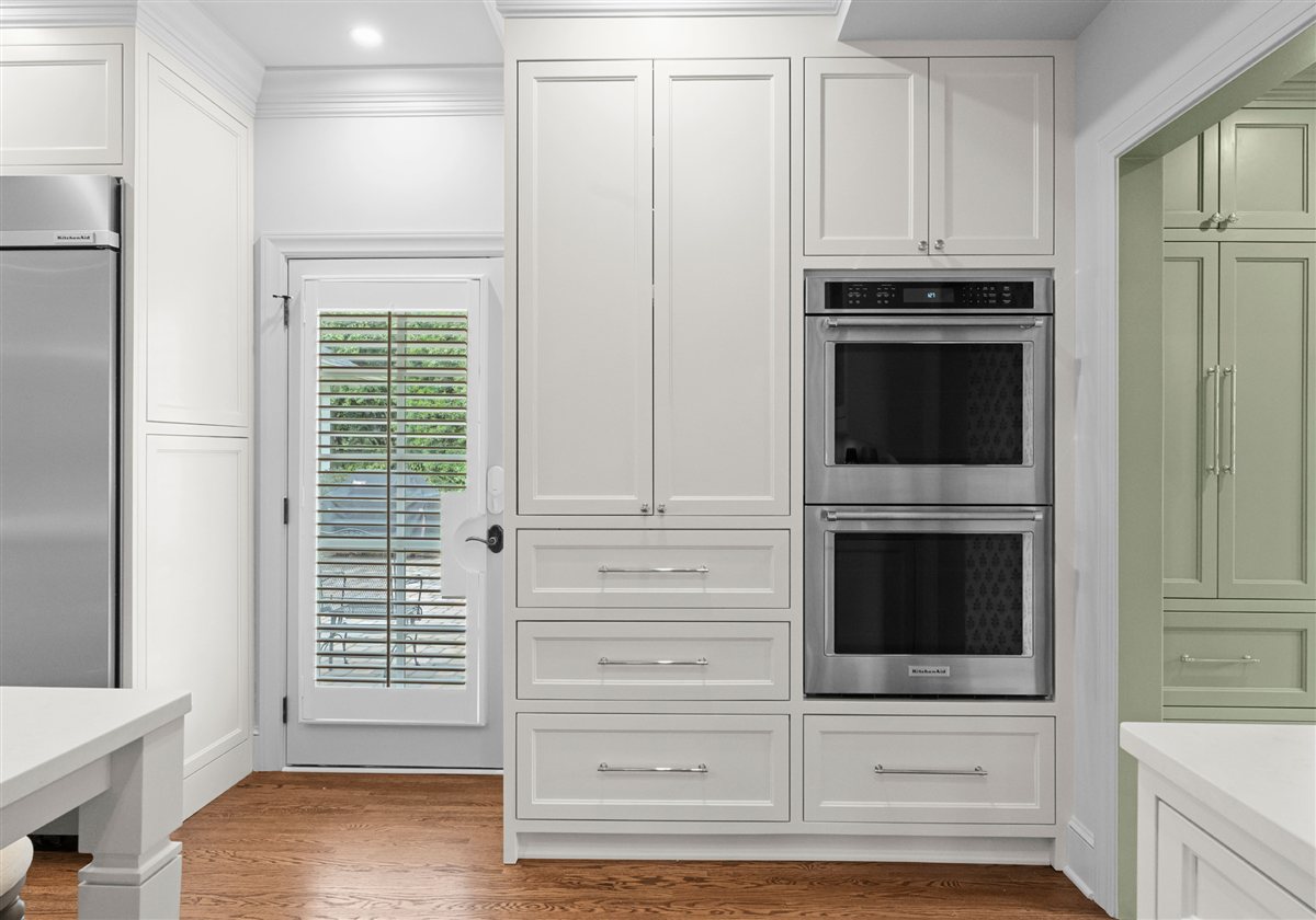 Double wall ovens and tall white cabinetry, Providence Park historic home