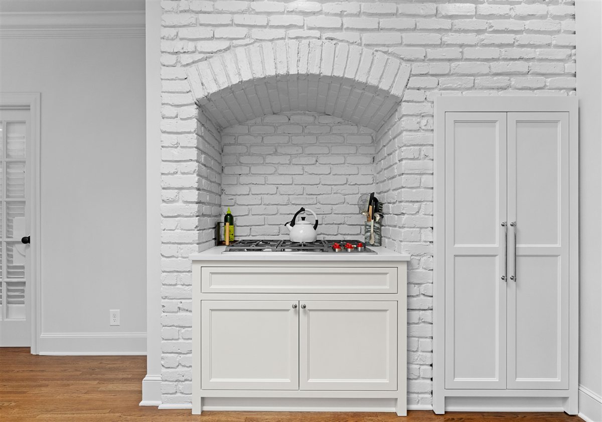 Painted brick range alcove with an arched opening, Providence Park historic home
