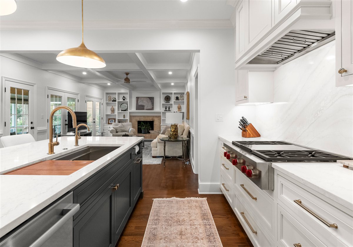 White kitchen with a charcoal island, brass faucet and gas range, Providence Plantation kitchen renovation