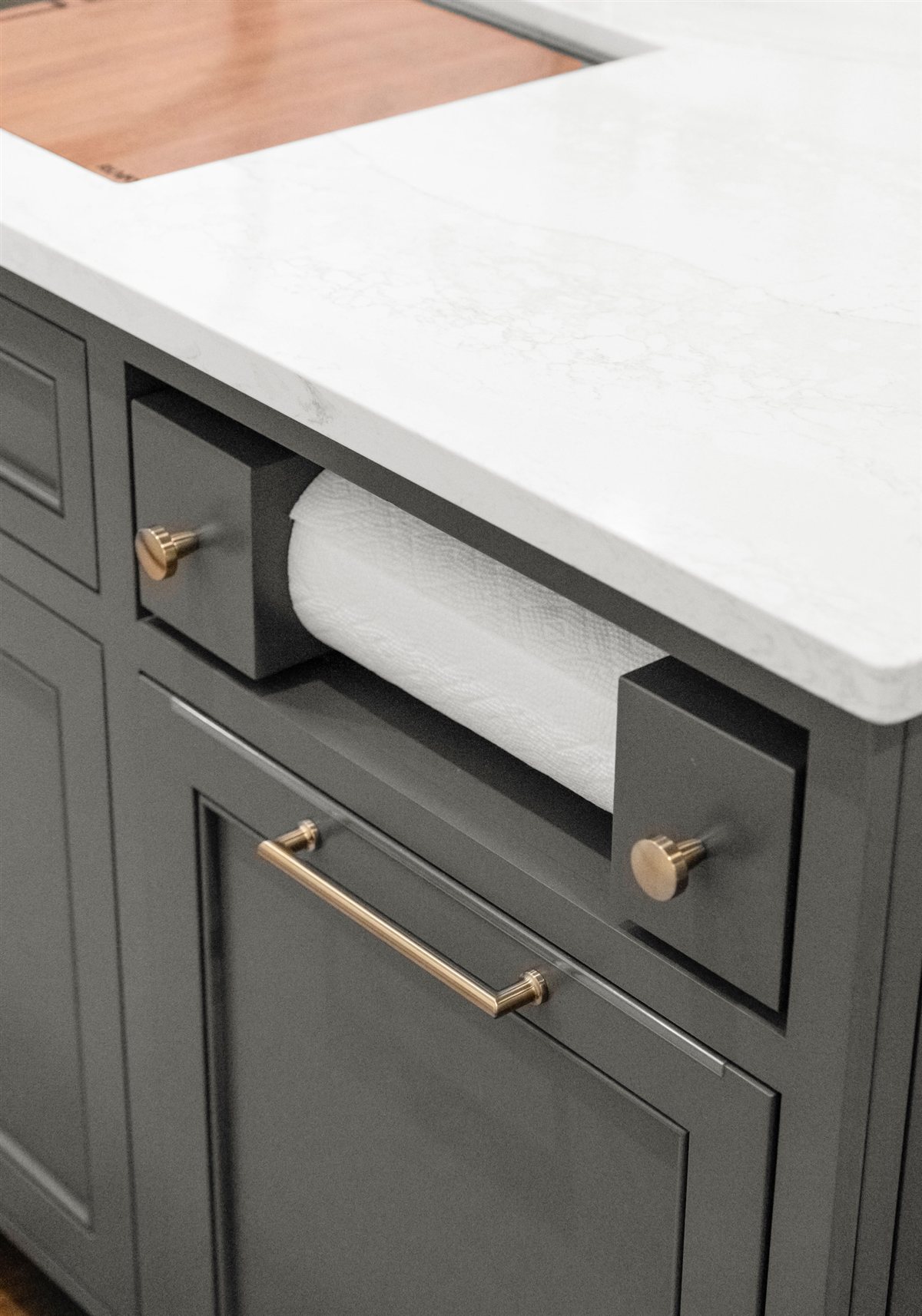 Charcoal cabinet with a brass pull and paper towel drawer, Providence Plantation kitchen