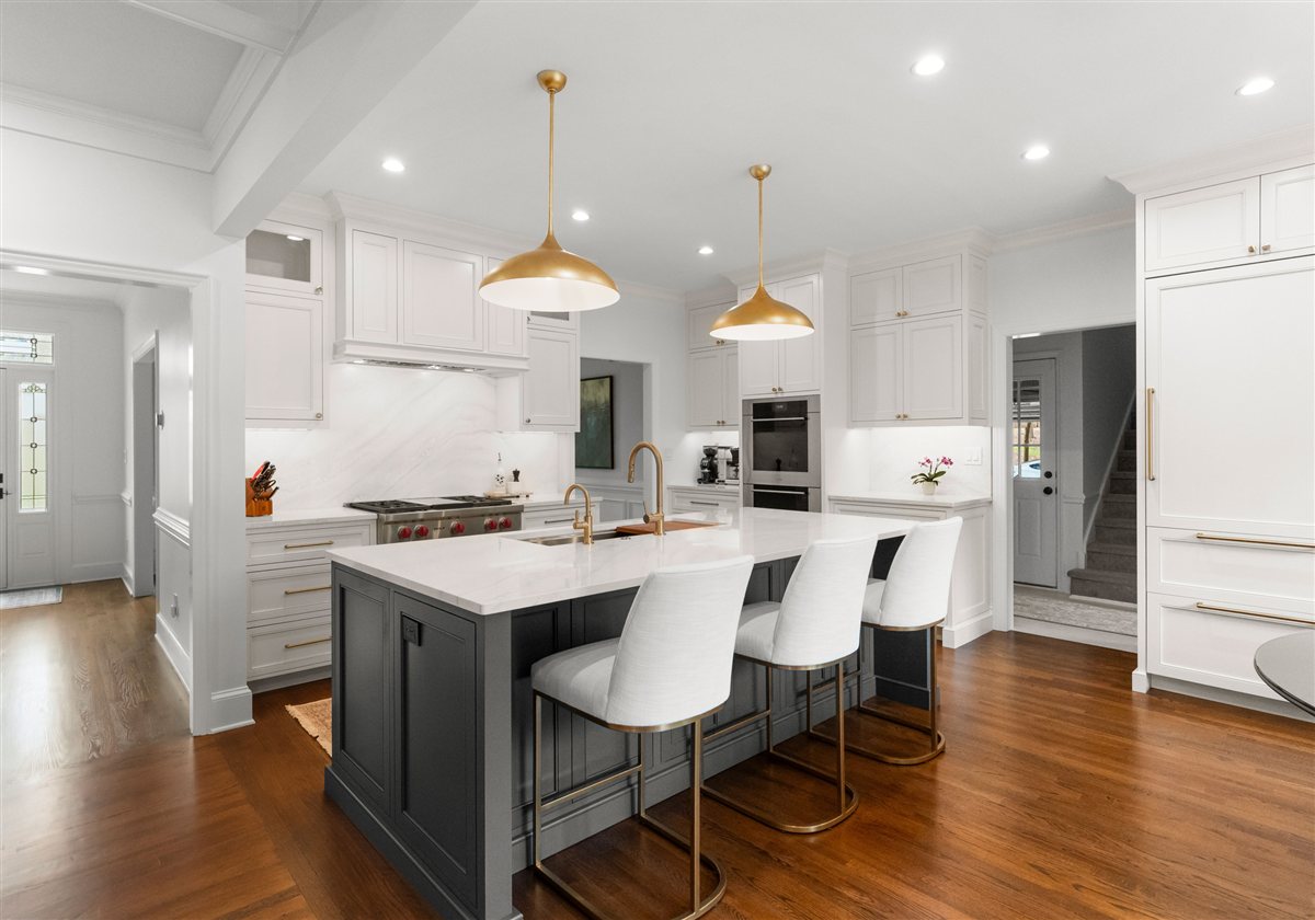 Charcoal island with white stools and brass pendants, Providence Plantation kitchen