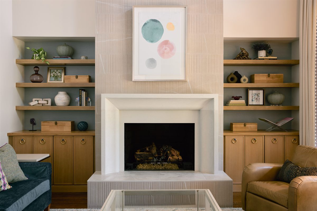 Living room fireplace with a cast stone surround and white oak floating shelves, Providence Springs, Charlotte