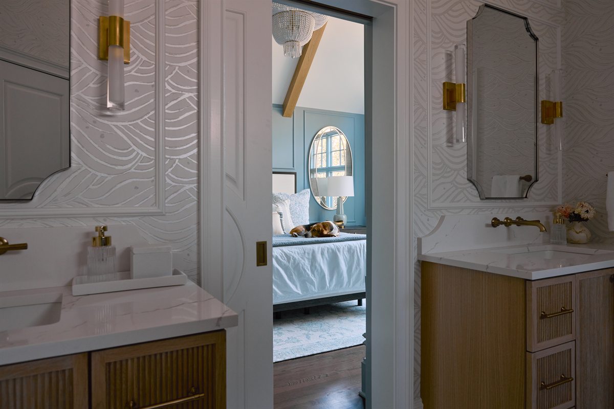 Primary bath vanity wall with textured white tile and a pocket door open to the bedroom, Providence Springs, Charlotte