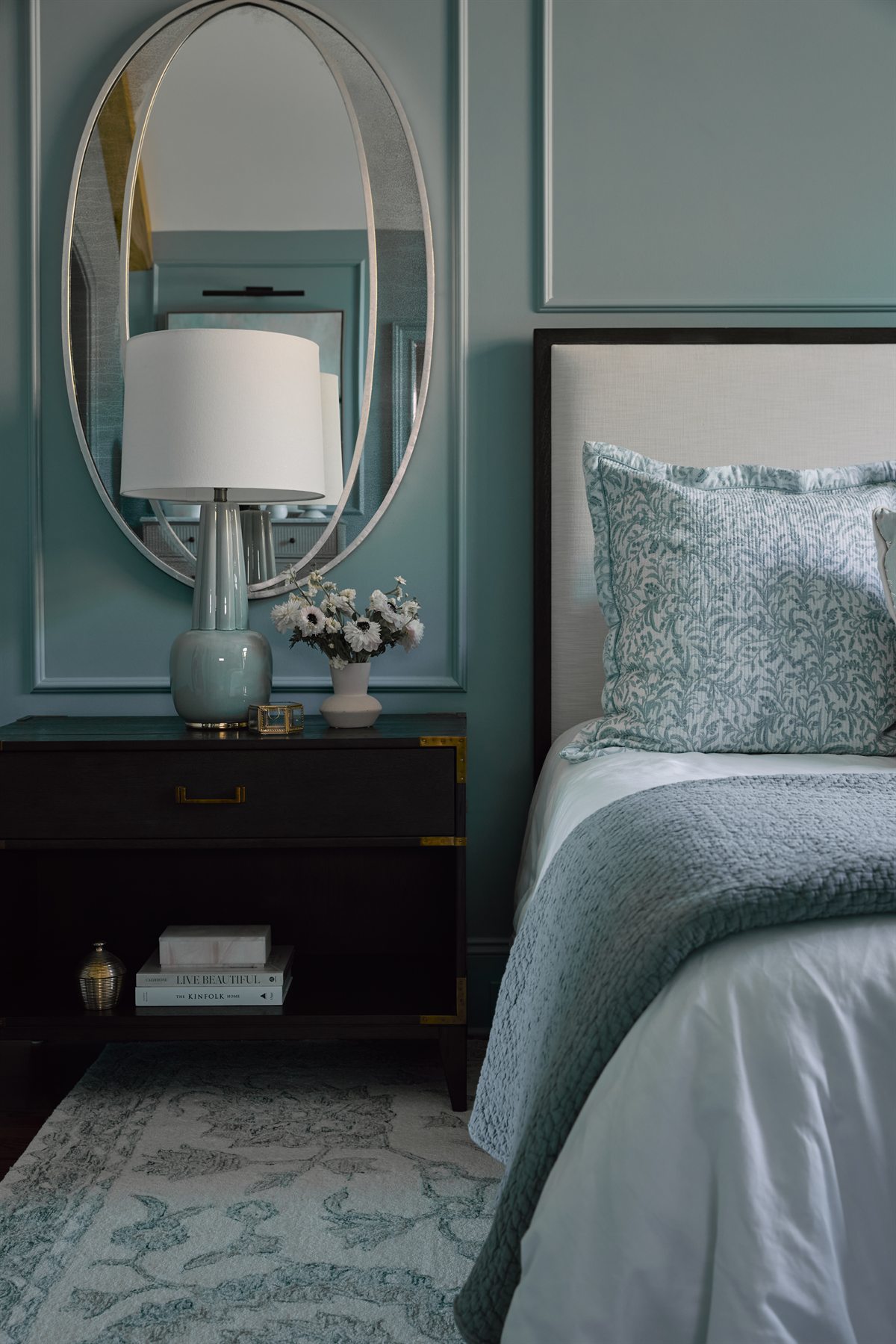 Primary bedroom with an oval mirror, blue-gray walls and panel molding, Providence Springs renovation, Charlotte