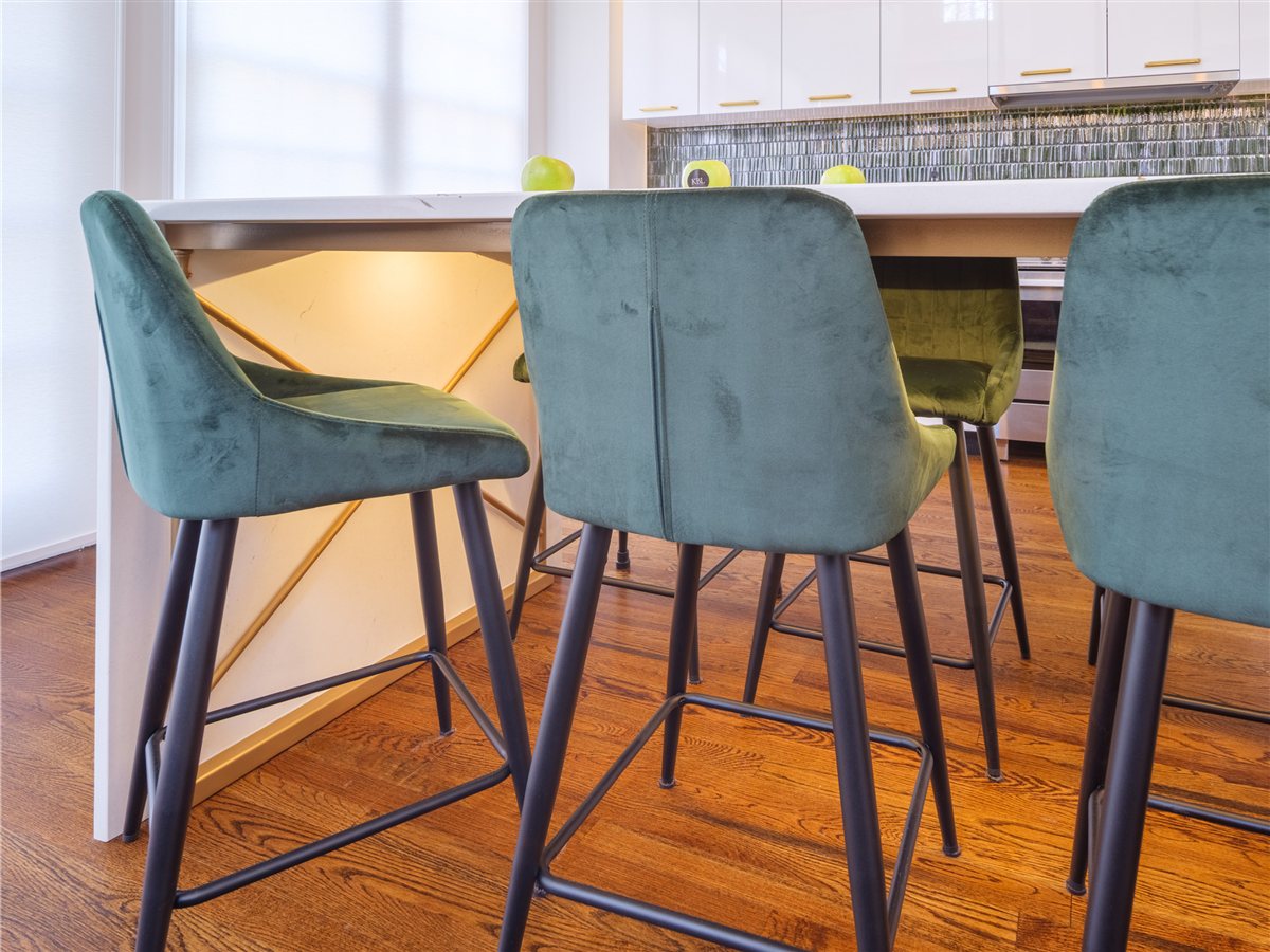 Teal velvet counter stools at the Cambria quartz waterfall island, SouthPark kitchen