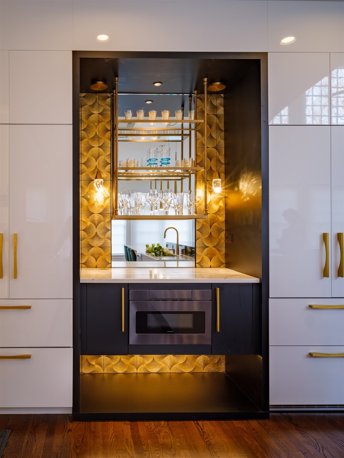 Lit bar cabinet with a gold backing, SouthPark kitchen
