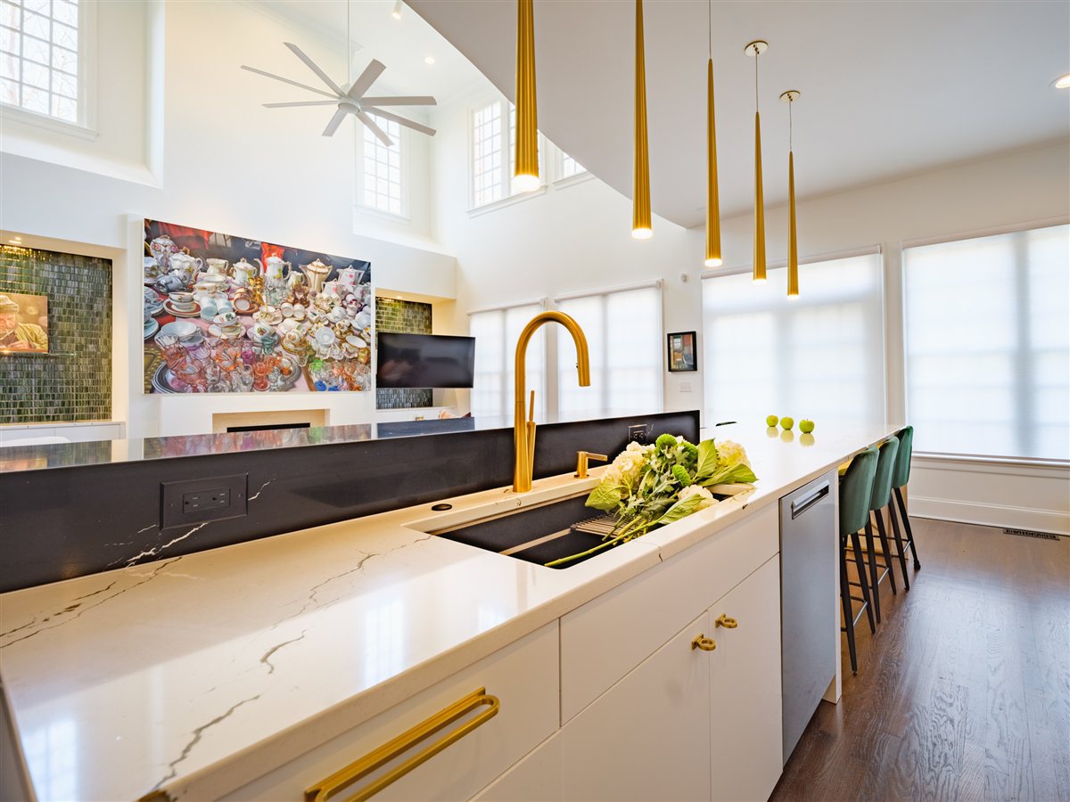 Brass faucet and black countertop with green tile, SouthPark kitchen