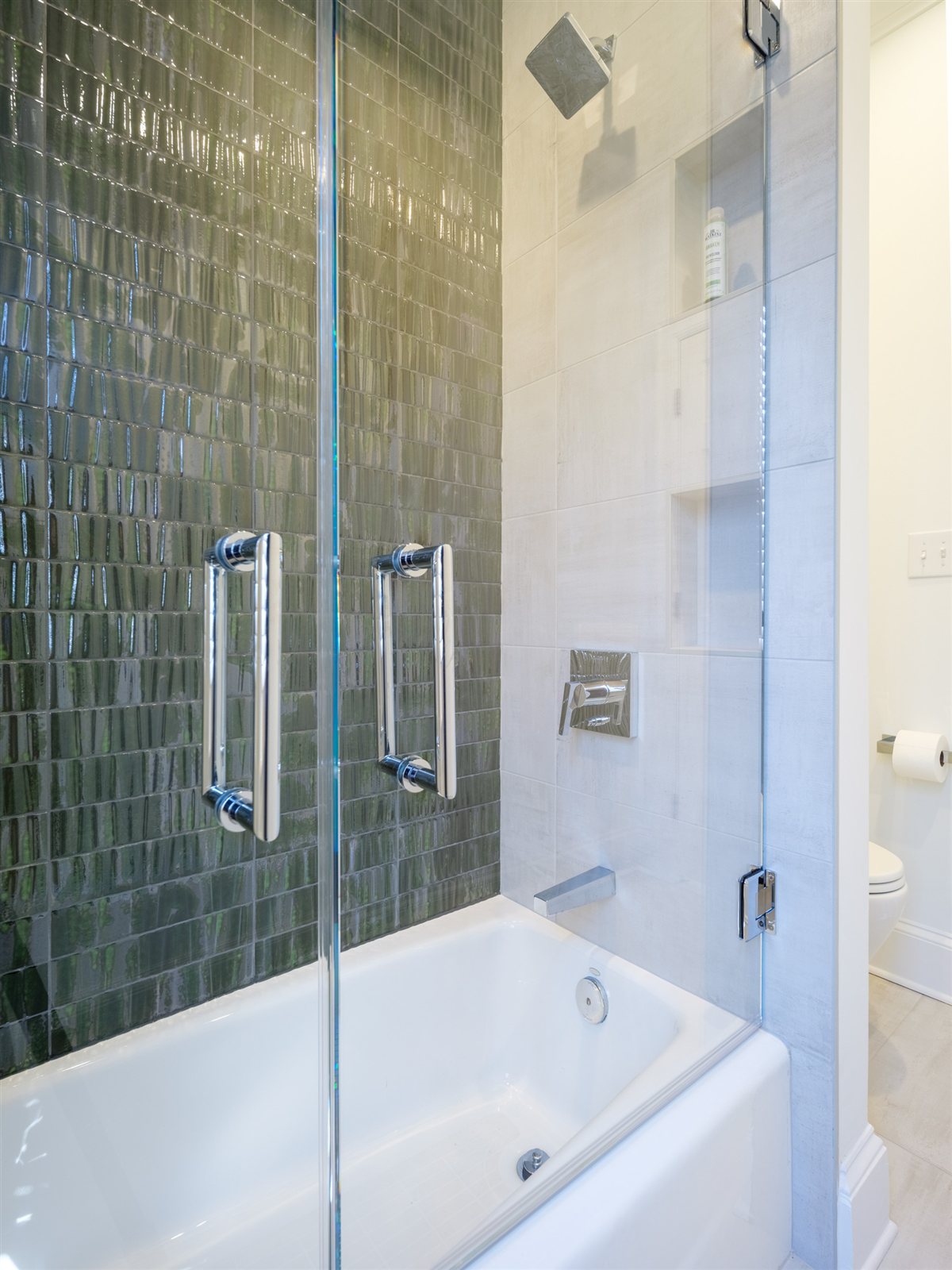 Shower with green glazed tile and a glass door, SouthPark renovation