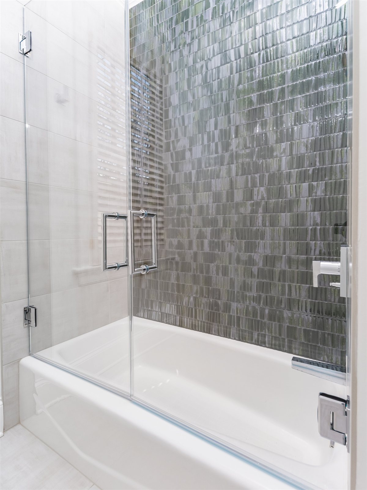 Bathtub with a glass shower screen and green tile, SouthPark renovation