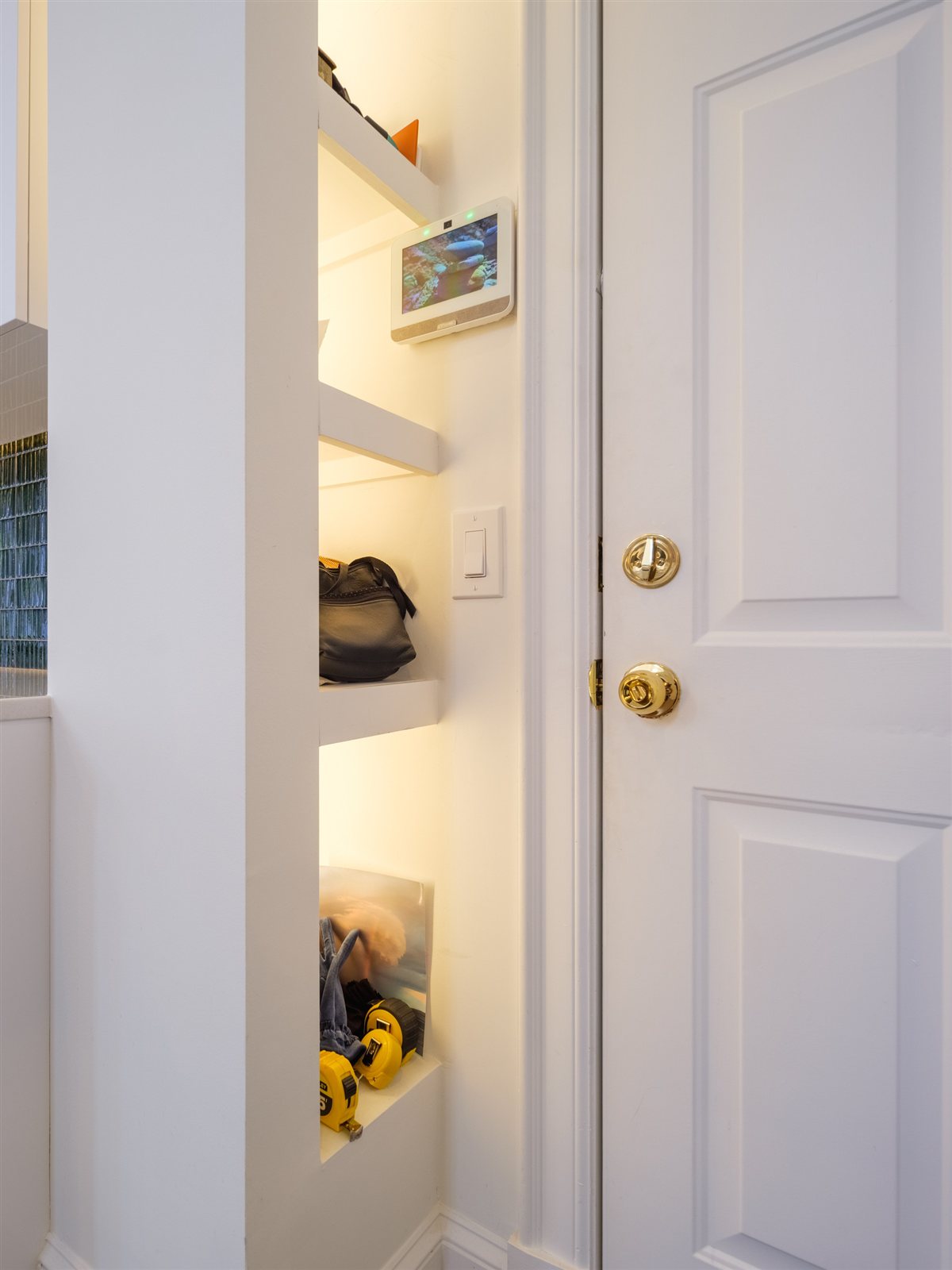 Lit niche shelving beside a paneled door, SouthPark renovation