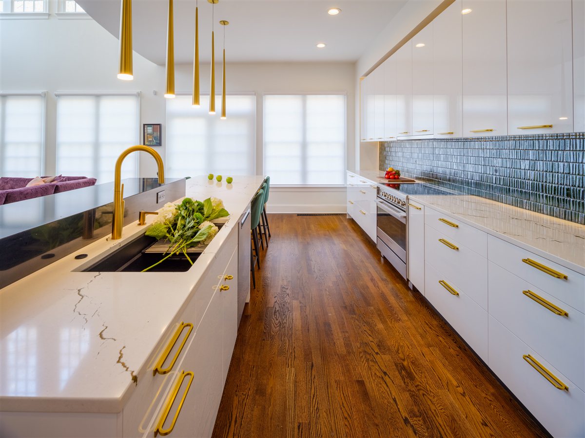 Sink run with a brass faucet and pendant lights, SouthPark kitchen