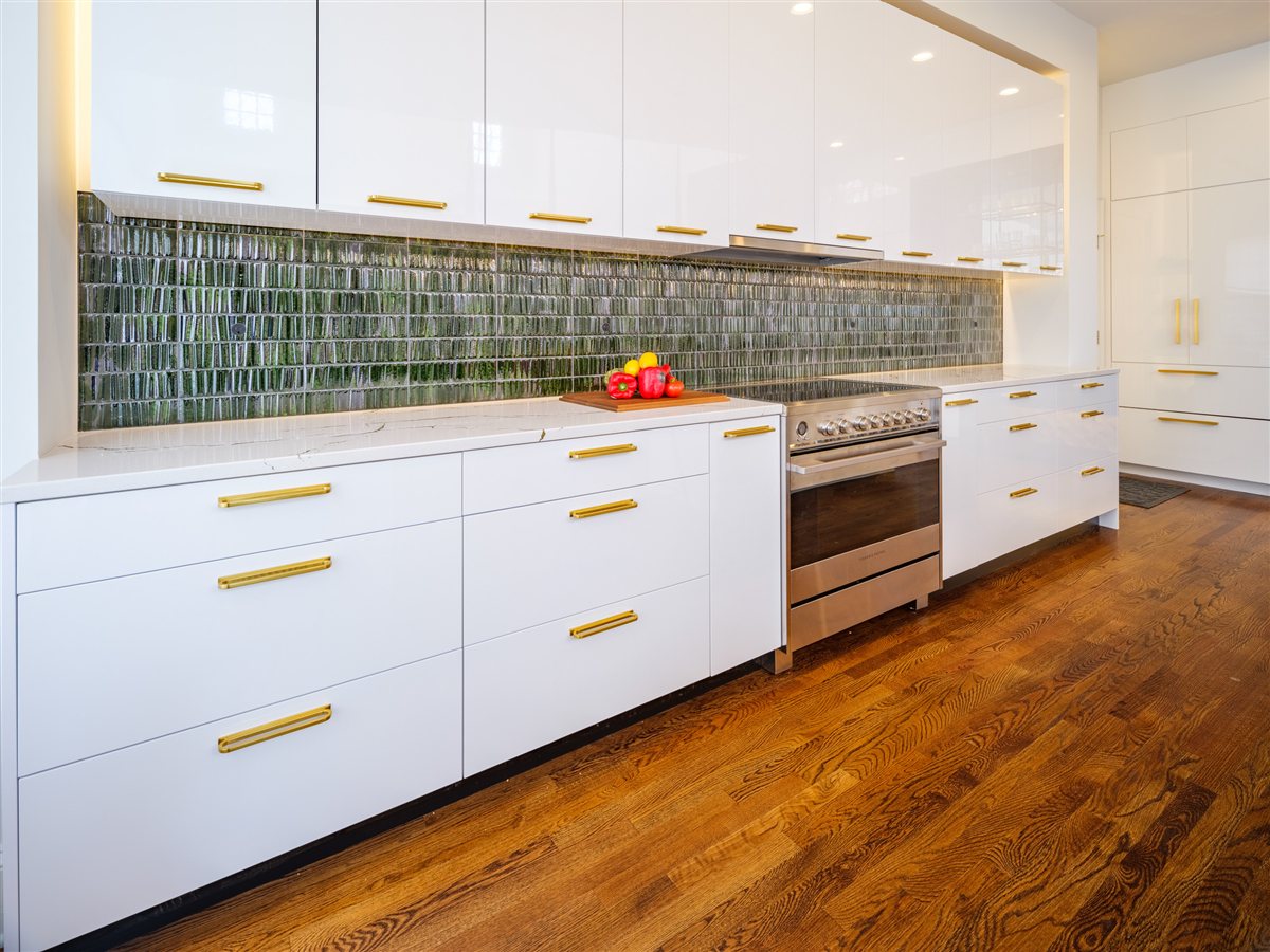 White cabinetry with brass pulls and a handcrafted green tile backsplash, SouthPark kitchen
