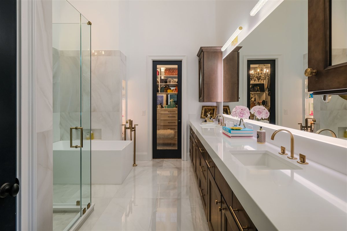 Glass shower beside the vanity and walk-in closet, Uptown primary suite