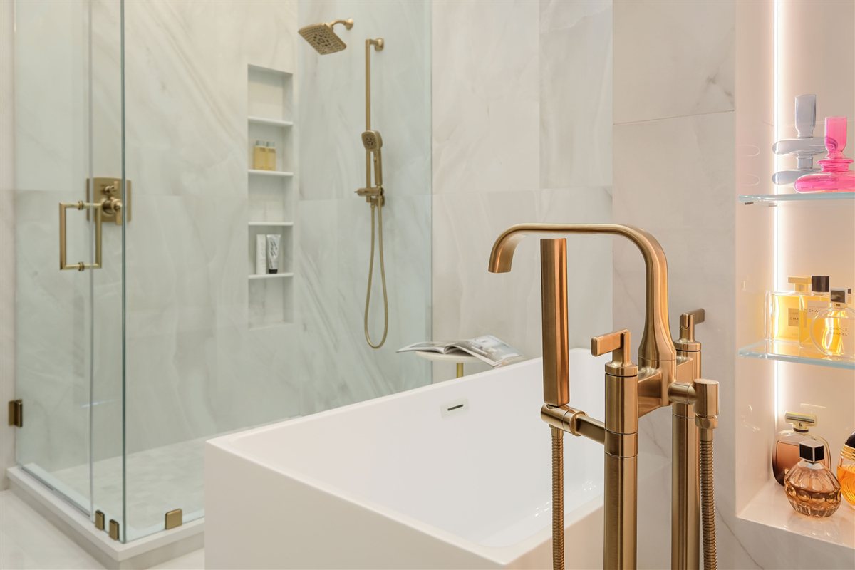 Veined tile shower with brass fixtures and a built-in niche, Uptown primary suite