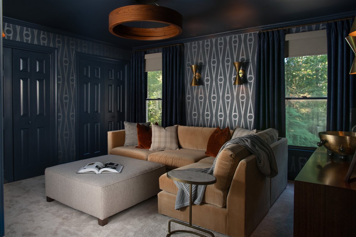 Den with navy walls, patterned wallpaper, a sectional and a wood ring ceiling light, Valencia Terrace renovation and addition in SouthPark