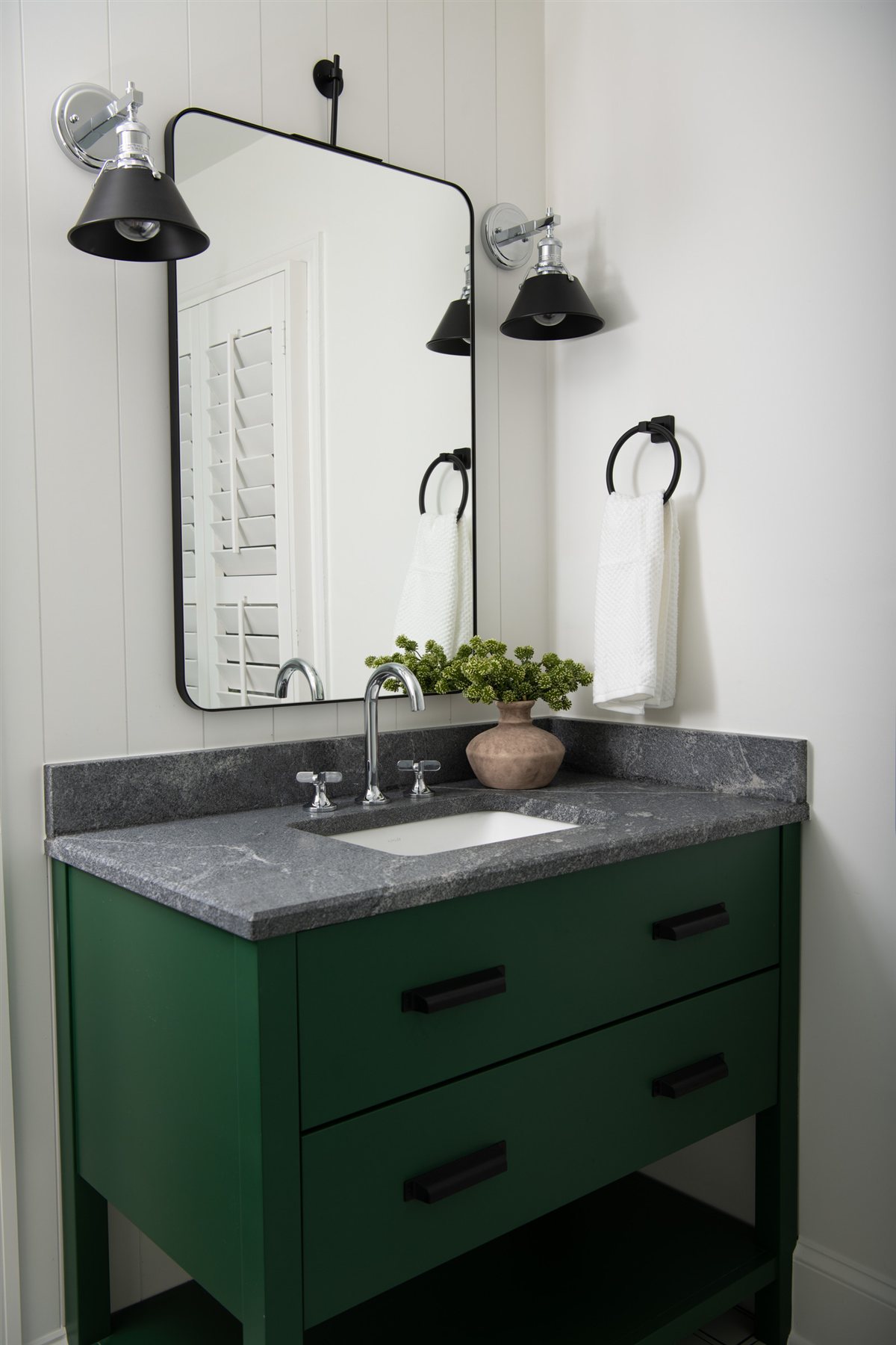Green vanity with a gray countertop and black sconce, Valencia Terrace renovation