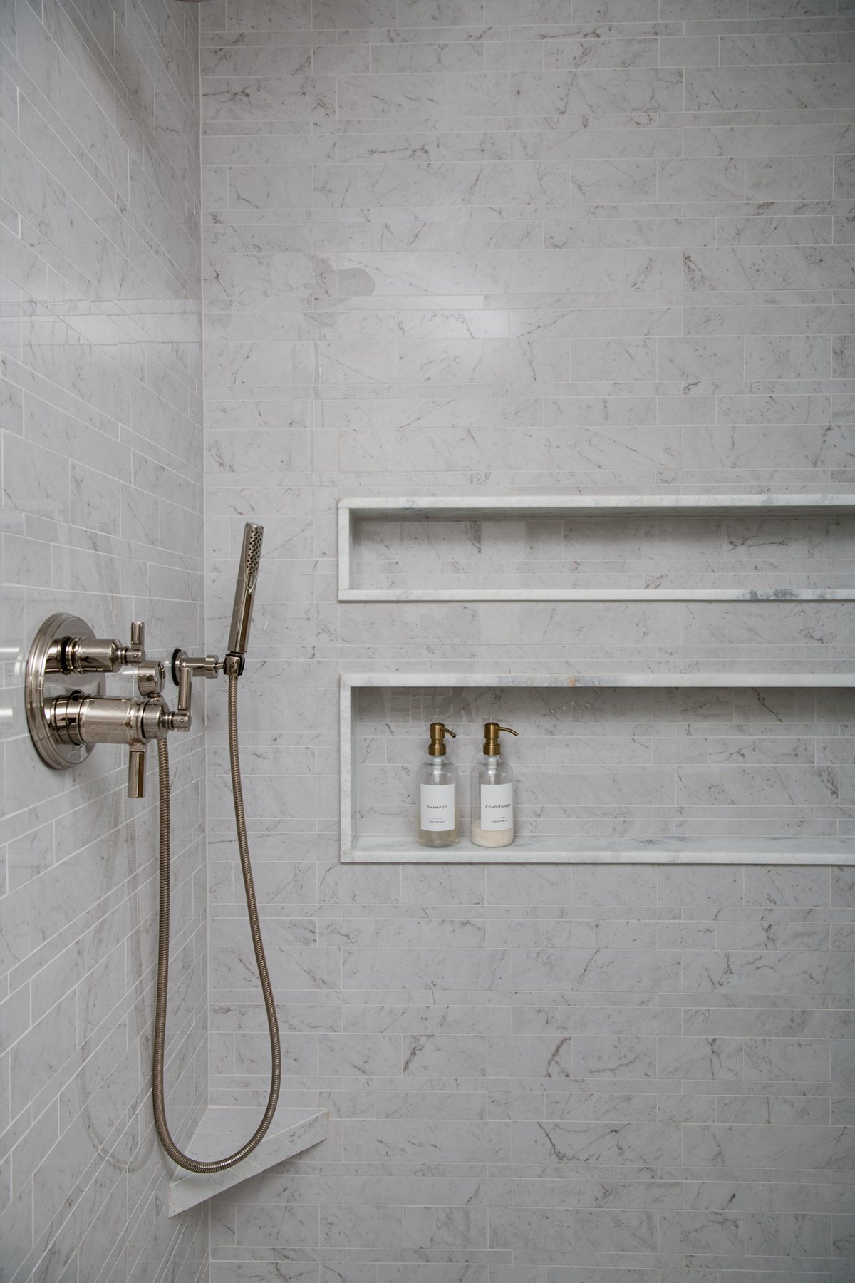 Shower wall with a niche and brushed fixtures, Valencia Terrace addition