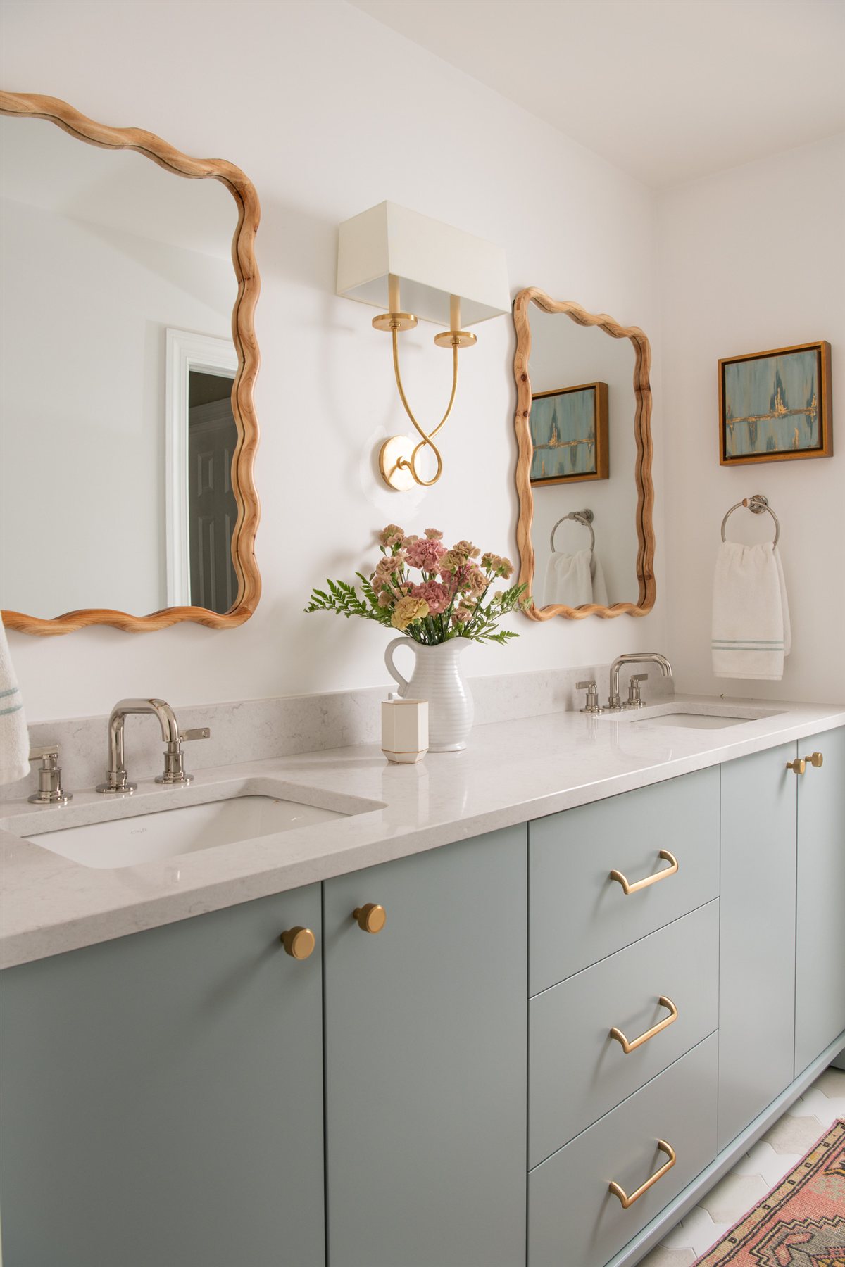 Pale blue vanity with a scalloped mirror, Valencia Terrace renovation