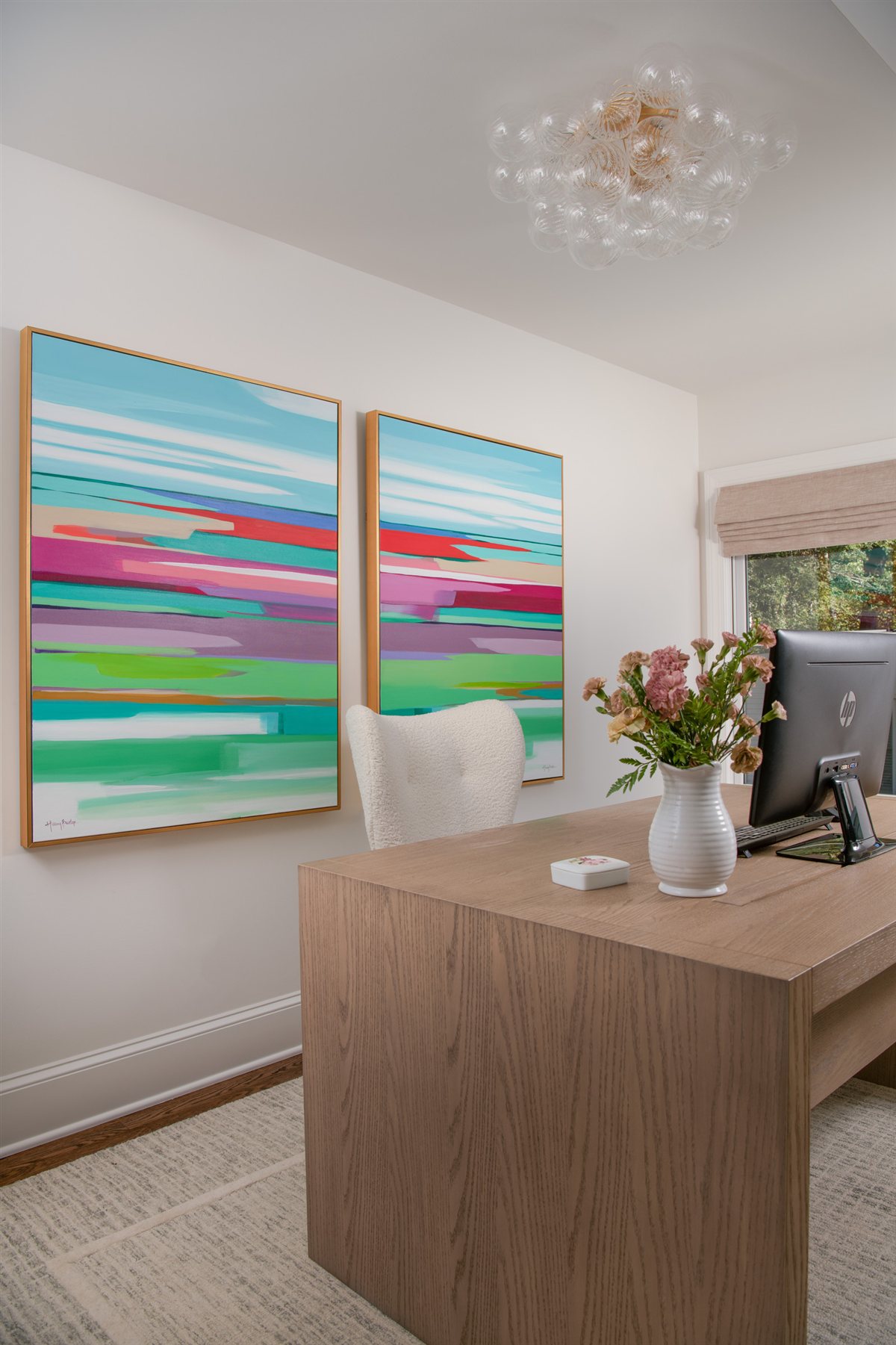 Wood desk beneath colorful abstract artwork, Valencia Terrace renovation