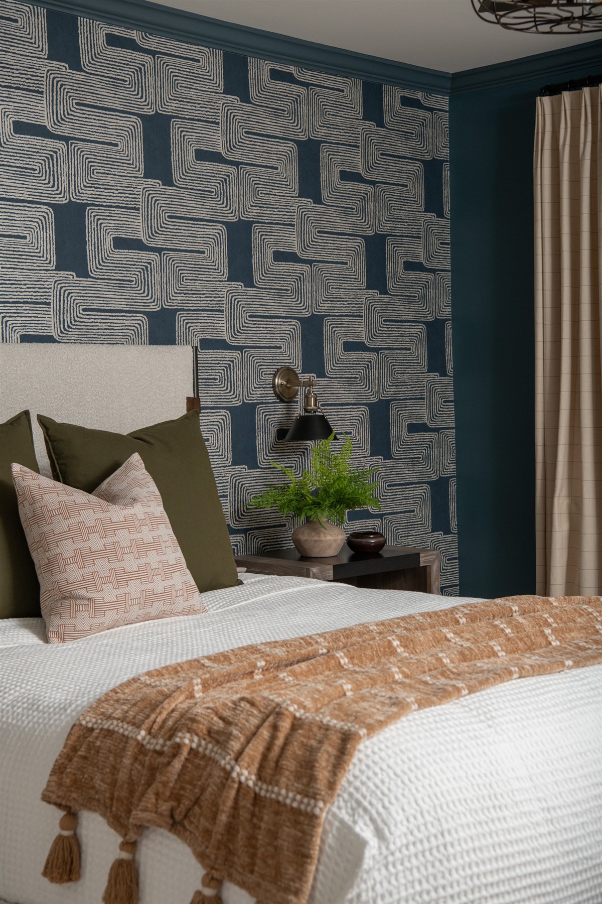 Bedroom with patterned wallpaper and a bench at the foot of the bed, Valencia Terrace renovation