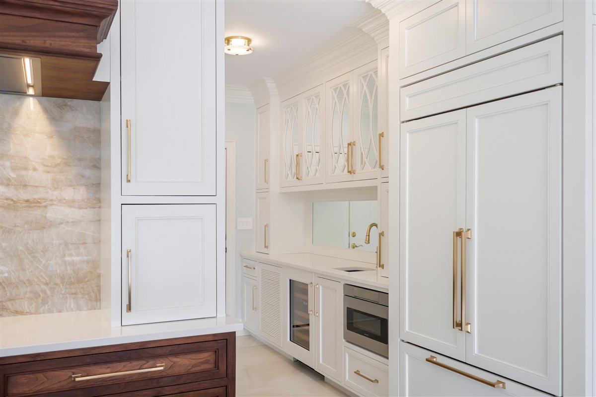 White tall cabinetry and a paneled refrigerator, Waxhaw quartzite kitchen remodel